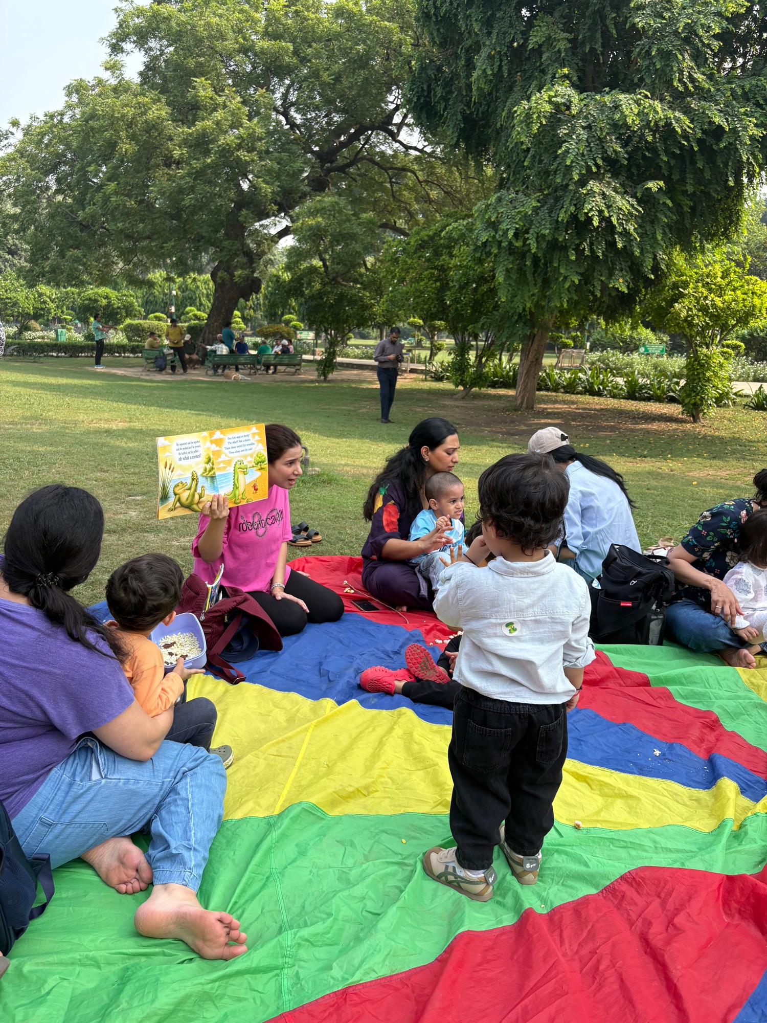 Outdoor picture book reading session with young children and families