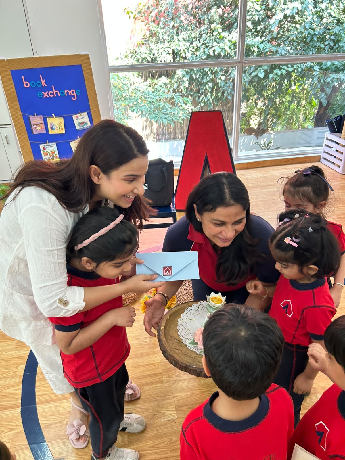 Children presenting a gift during a classroom book exchange